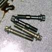 Old and new (black) rod bolts. Note difference in length!